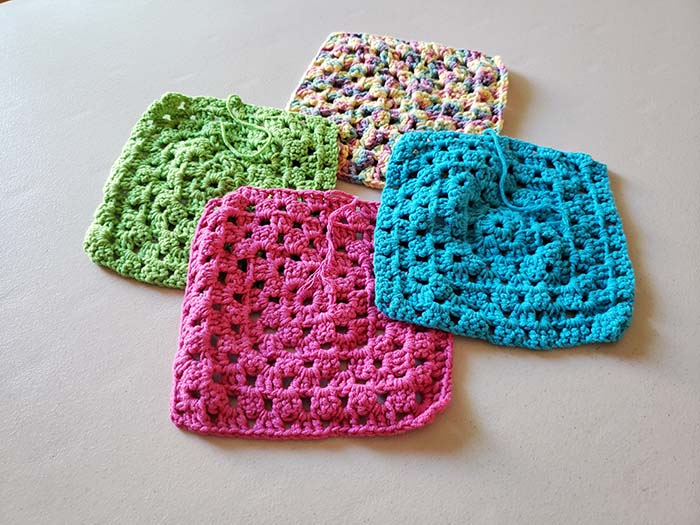 Unblocked crochet squares ready for finishing and blocking