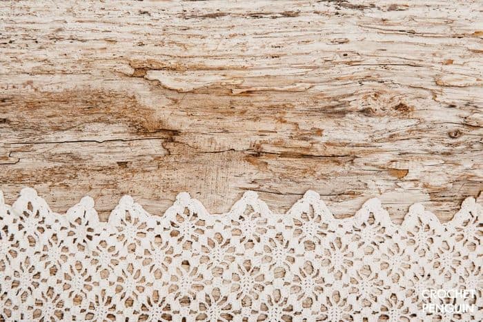 Fine lace crochet on a wooden surface