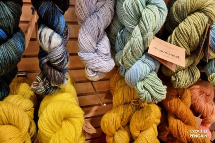 Types of Yarn For Crochet - different colored hanks of hand dyed yarns